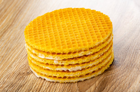 Stack of wafers with filling on brown wooden tableの写真素材