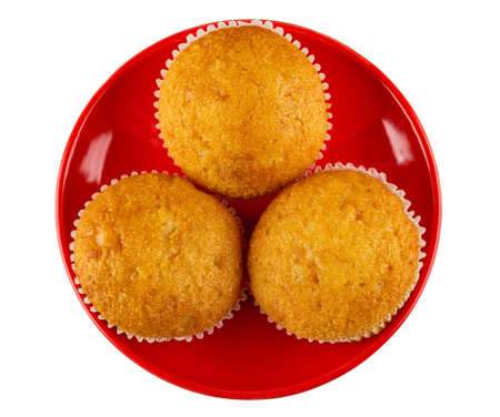 Three small muffin in red glass saucer isolated on white background. Top view