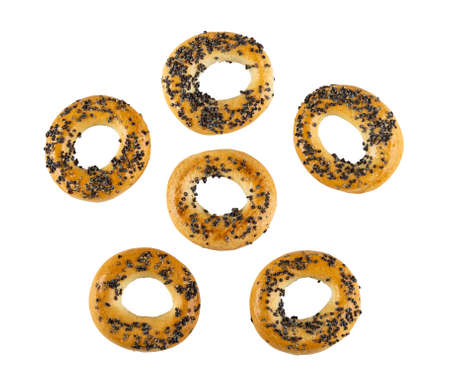 Few bread rings with poppy seeds isolated on white background. Top view