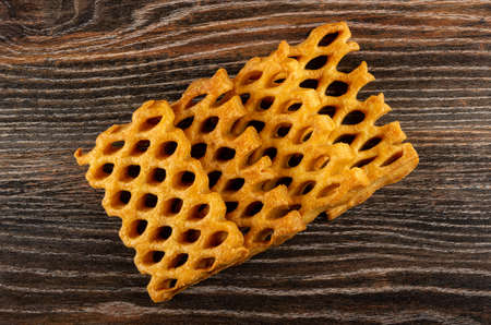 Few wicker puff cookies on dark wooden table. Top view