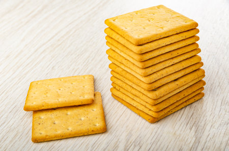 Stack of dry cookies, two crackers on wooden table. Top viewの写真素材