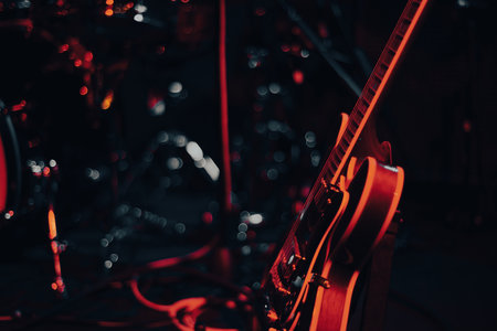 close up of an electric guitar on stage under red, blue and purple neon glow stage lights of club. live music conceptの写真素材