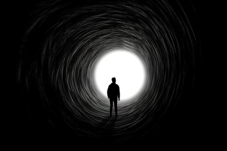 Silhouette of a man in a tunnel on a black backgroundの素材