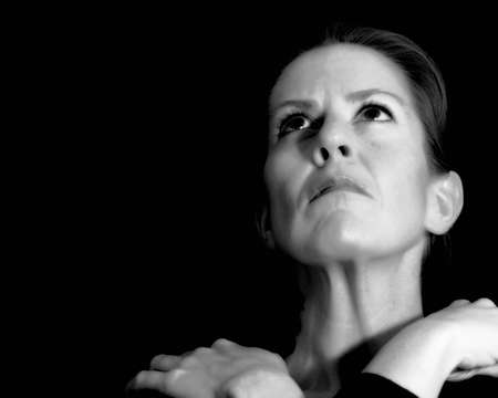 woman looking up thoughtfullyの写真素材