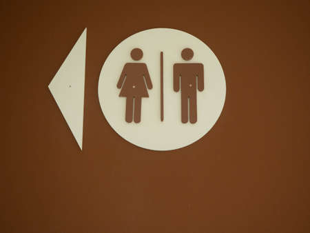 Women & Men Bathroom Sign on brown backgroundの写真素材
