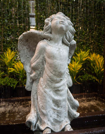 Cute little cupid sculpture decorate in the gardenの写真素材