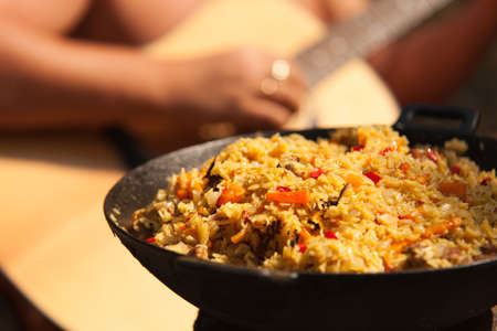 Dish with Afghan Plov with guitar playing guy backgroundの写真素材