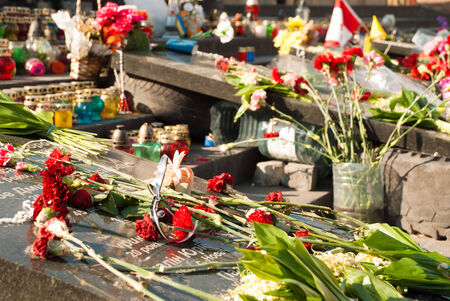 KIEV, UKRAINE - May 12, 2014: Ukrainian revolution. Euromaidan.People bringing flowers and candels to places where killed many peoples on the Maidan Nezalezhnosti on 12 MAY 2014 in KIEV,UKRAINEのeditorial素材