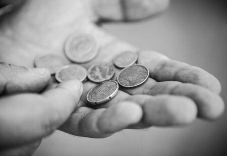 Euro Cent coins in the hands of hard workerの写真素材