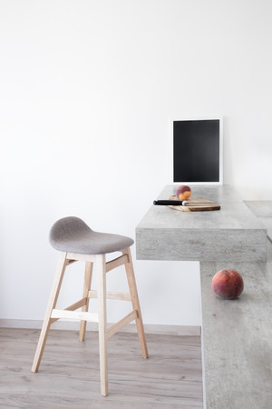 Part of modern scandinavian style kitchen: bar counter with bar counter and peaches.の写真素材