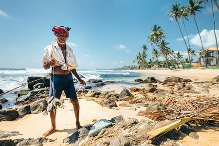 Local Sri Lanka lankian old fisherman portrait on the tropic sand coast beachの写真素材