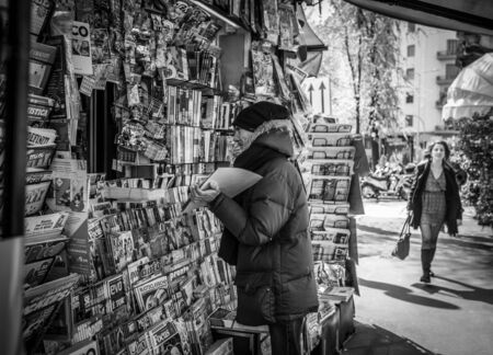 Milan, Italy - March 23, 2016:  Man shows something to newspaper seller in Milan, Italyのeditorial素材