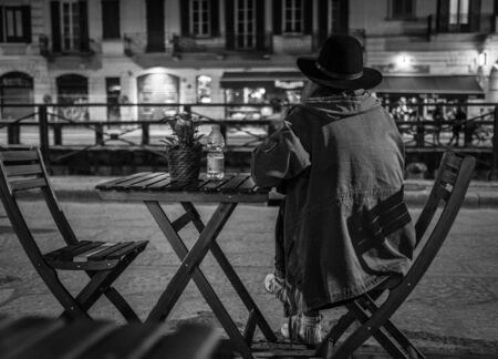 Milan, Italy - March 23, 2016: Alone female itting at the caffe table and waiting for somebody in Milan, Italyのeditorial素材