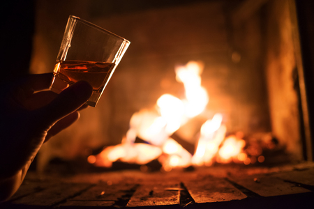 Whiskey glass with bonfire background cropの写真素材