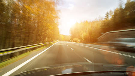 Front view of the highway road passing the country side inside the fast car long exposure shoot