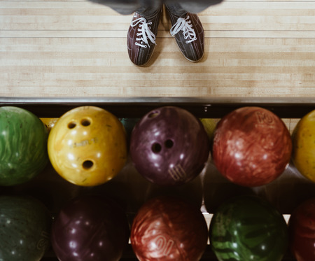 Bowling shoes with multicolored bowling balls POV Top viewの写真素材