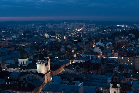Night aerial shoot of old Lviv city in Ukraine at the Lviv main square (Rynok square) during a...