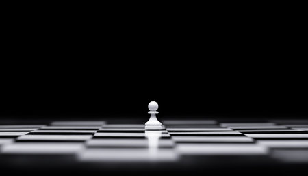 Black and White Chess Board scene with single white pawn with black background. Graphical minimalism concept photo with big copy space.の素材