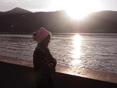 Elderly woman looking over the lakeのeditorial素材