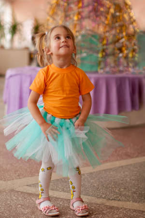 Cute smiling little girl wearing tutuin the christmas decorated roomの写真素材