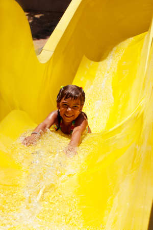 Happy child having fun in aquaparkの写真素材