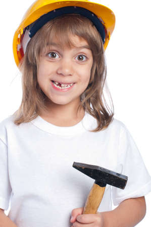 Funny little girl with hammer  wearing yellow hard hat isolated on white backgroundの写真素材