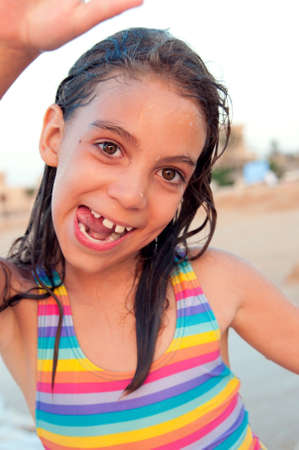 Happy laughing little girl on beachの写真素材