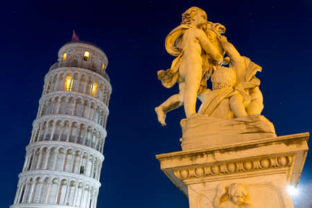 Leaning Tower of Pisa with statue after sunset, Tuscany, Italyの写真素材