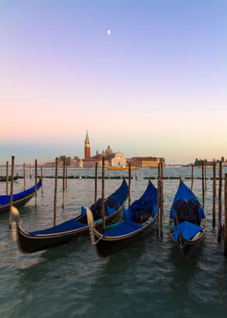 Gondolas at sunset with San Giorgio di Maggiore church, Venice, Venezia, Italyの写真素材