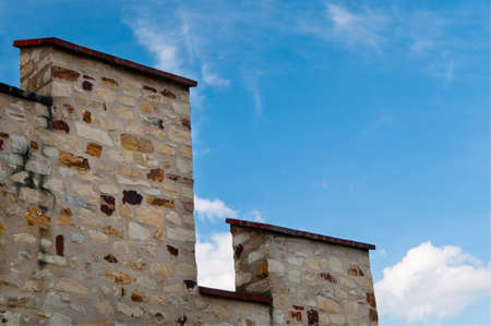 Medieval castle stony wall against blue skyの写真素材
