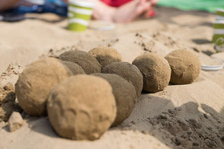 Sand balls on the beach divided into two rowsの写真素材