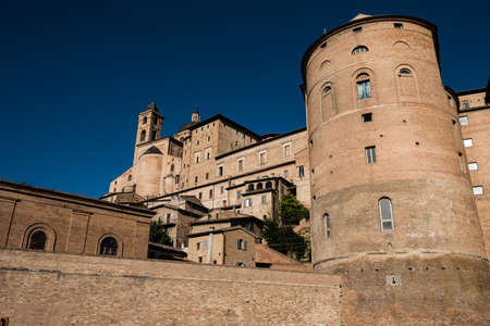 View from below of the imposing ducal palace of Urbino, Italy, during a splendid sunny summer day. During the Renaissance the city became an international art center.のeditorial素材