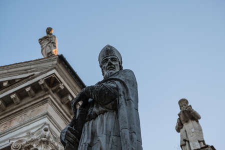 three statues of religious marble figures near the main church of Urbino, Italy. They date back to the Renaissanceのeditorial素材