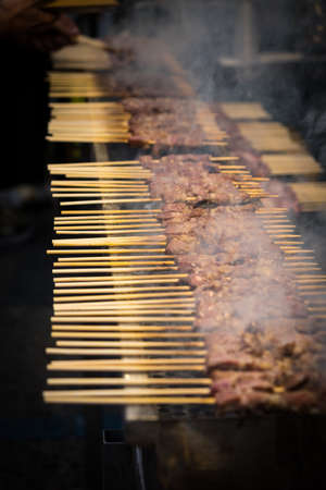 A typical central Italy dish: lamb "arrosticini". They are thin skewers of mutton cooked on the grillの写真素材