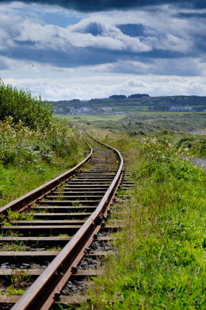 A railway that gets lost in the Irish countryside, giving a sense of infinityの写真素材
