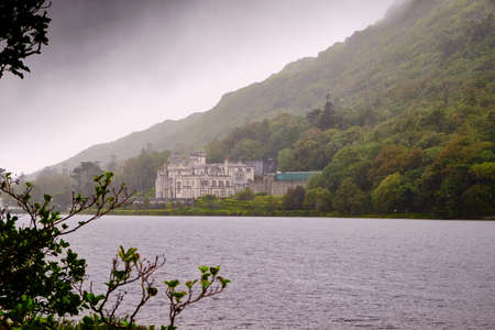 Kylemore Abbey in Connemara, County Galway, Ireland, during a rainy day.The abbey was founded for...