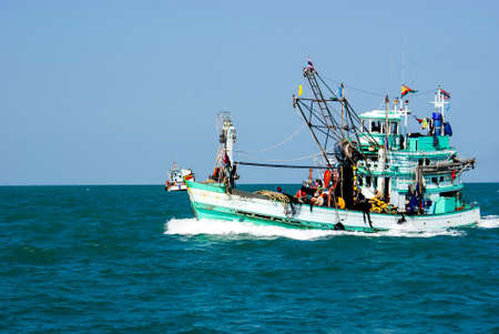 Old thai fishing boat sailing in the middle of the sea