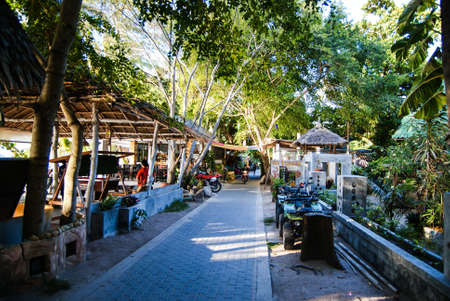 KOH TAO, THAILAND, Island life. A pedestrian street along the coast of Sayri beach is sometimes used by motorcyclesの写真素材