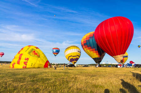 18.07.2015. Minsk. Belarus. Hot air balloons on the field are preparing to take off at the festival "70 years of peaceful sky" ("70 let mirnogo neba")のeditorial素材