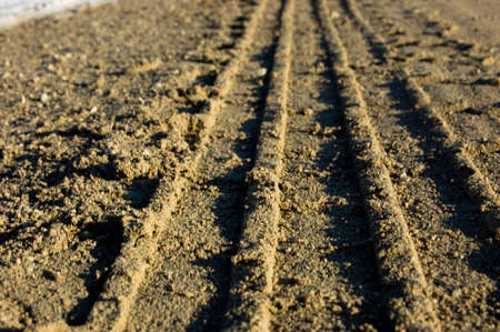 Trace from an automobile tire cover on road from gravel. A backgroundの写真素材