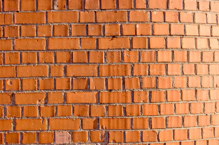 Non-uniformly shined wall from a red brickの写真素材