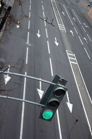 empty street in the afternoon with a green traffic light without carsの写真素材