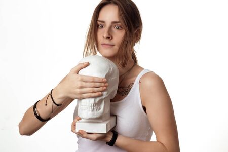 the girl with the scared closes his eyes plaster skull isolate on white background