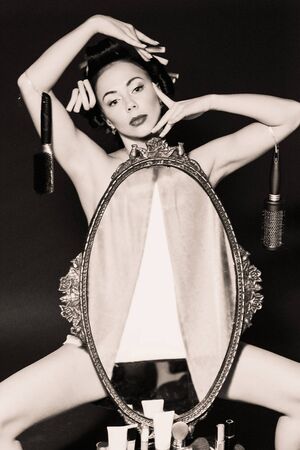 the girl in the mirror. Conceptual picture of the love of girls to self-love. Retro style with...
