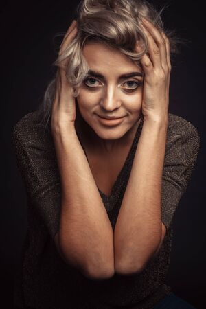 Studio portrait of a young beautiful girl on a black background