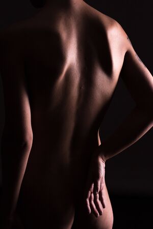 Sexy woman from back, black background, light line contours, abstract shotの写真素材
