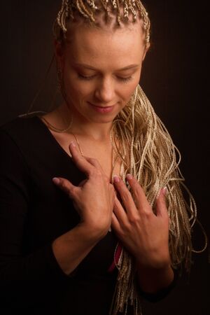 Fashion studio shoot woman . with a creative colorful hairstyle in the form of a pigtail braided...