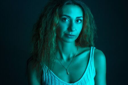High Fashion model woman in colorful bright lights posing in studio, portrait of a beautiful girl. Artistic colorful design. Party concept,の写真素材