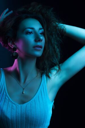High Fashion model woman in colorful bright lights posing in studio, portrait of a beautiful girl. Artistic colorful design. Party concept,の写真素材