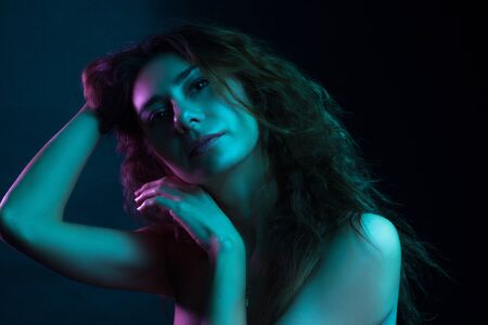 High Fashion model woman in colorful bright lights posing in studio, portrait of a beautiful girl. Artistic colorful design. Party concept,の写真素材